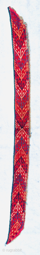 “An early 19th-century Tekke Turkmen embroidered band, featuring intricate abstract motifs in shades of red, blue, yellow, white, dark green, and apricot yellow. This embroidery is entirely silk, stitched onto a red-brown  ...