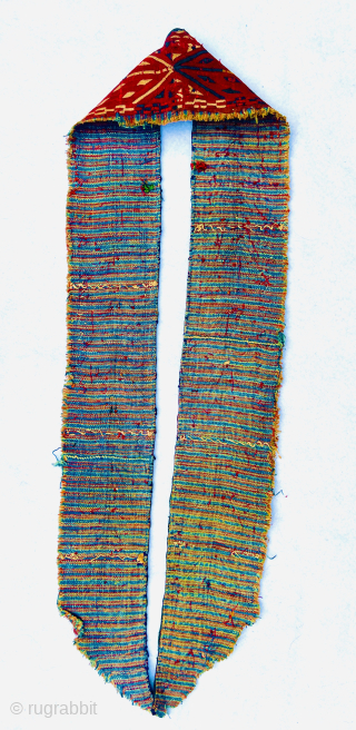 “An early 19th-century Tekke Turkmen embroidered band, featuring intricate abstract motifs in shades of red, blue, yellow, white, dark green, and apricot yellow. This embroidery is entirely silk, stitched onto a red-brown  ...