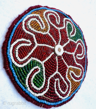 Antique north Afghanistan glass beaded  beads on cotton with Shell button In the center. Diameter 14cm Please Contact this email for more information.
hamidparsacarpet@yahoo.com         