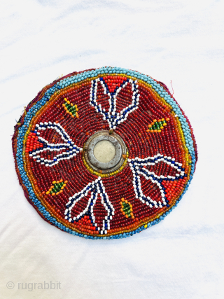 A set of 3 antique pieces from northern Afghanistan, decorated with glass beads on cotton and felt fabric. One features a shell button at the center, and another has a round metal  ...