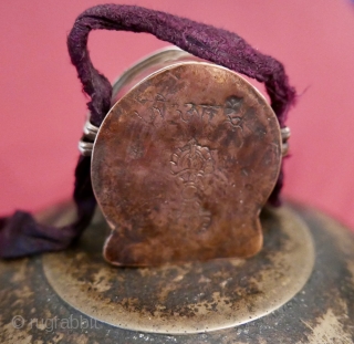 18th c. Tibetan Buddhist Silver Bhairava 'Gau' depicting Bhairava(Mahakala),  a fierce deity protector of Buddhist dharma;  copper backing,  efficacious for contact with the bare skin of the traveling lama;  ...