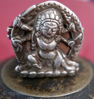 18th c. Tibetan Buddhist Silver Bhairava 'Gau' depicting Bhairava(Mahakala),  a fierce deity protector of Buddhist dharma;  copper backing,  efficacious for contact with the bare skin of the traveling lama;  ...
