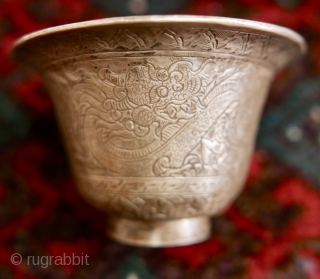 18th-19th c Tibetan silver teacup holder (dkar yol yu),  lid (kha leb)and cup (phor pa) with very finely chased and repousse-worked Buddhist auspicious symbols and a splayed lotus fineal surmounted by  ...