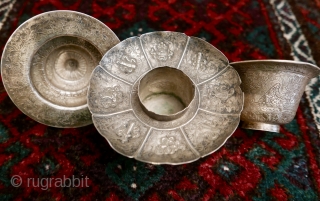 18th-19th c Tibetan silver teacup holder (dkar yol yu),  lid (kha leb)and cup (phor pa) with very finely chased and repousse-worked Buddhist auspicious symbols and a splayed lotus fineal surmounted by  ...