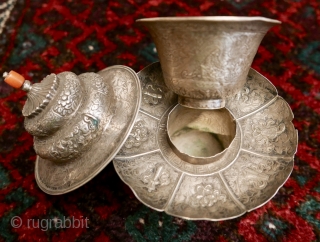 18th-19th c Tibetan silver teacup holder (dkar yol yu),  lid (kha leb)and cup (phor pa) with very finely chased and repousse-worked Buddhist auspicious symbols and a splayed lotus fineal surmounted by  ...