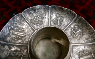 18th-19th c Tibetan silver teacup holder (dkar yol yu),  lid (kha leb)and cup (phor pa) with very finely chased and repousse-worked Buddhist auspicious symbols and a splayed lotus fineal surmounted by  ...