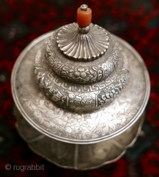 18th-19th c Tibetan silver teacup holder (dkar yol yu),  lid (kha leb)and cup (phor pa) with very finely chased and repousse-worked Buddhist auspicious symbols and a splayed lotus fineal surmounted by  ...