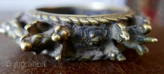 Lost-wax-cast brass bangle,  called a 'Virkangan',  or 'powerful hero' bangle;  worn by Shaivite ascetics.  Around the perimeter are symbols associated with Shiva:  the lingam;  the bull,  ...