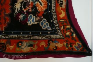 Tibetan saddle blanket,  first quarter 20th cent., good wool,  and full pile.  The fabric protecting the  back is not original.         