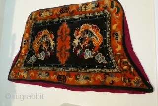 Tibetan saddle blanket,  first quarter 20th cent., good wool,  and full pile.  The fabric protecting the  back is not original.         