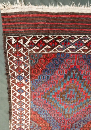 Mushwani Belouch/Baluch,  circa 1900,  2'10"x5'6",  wild and beautiful, with vivid red,  blue,  aubergine and white;  symmetrically knotted; kilim ends are complete except for small rough spot  ...