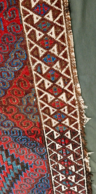 Mushwani Belouch/Baluch,  circa 1900,  2'10"x5'6",  wild and beautiful, with vivid red,  blue,  aubergine and white;  symmetrically knotted; kilim ends are complete except for small rough spot  ...