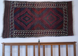 Mushwani Belouch/Baluch,  circa 1900,  2'10"x5'6",  wild and beautiful, with vivid red,  blue,  aubergine and white;  symmetrically knotted; kilim ends are complete except for small rough spot  ...