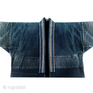 Sashiko Noragi - Shonai Step and Weave

One of the most visually arresting sashiko jackets from my collection. This sashiko noragi is from Shonai, Yamagata prefecture.

The entirety of this jacket is dyed with  ...