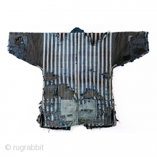 A tattered and stunning Japanese boro work jacket, or noragi. 

Layers of shima striped cottons give way to more stripes. 

Suitable for display or wear, this is one of our favorite jackets  ...