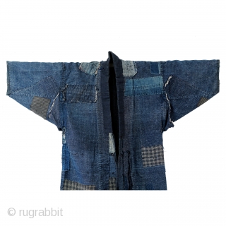 Boro Noragi - Meiji-era Indigo Cotton and Hemp Blend.

Thick, handspun indigo noragi with many mending patches. 

This jacket is heavy and warm and shows many, many years of use, but it still  ...