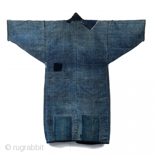 Boro Noragi - Meiji-era Indigo Cotton and Hemp Blend.

Thick, handspun indigo noragi with many mending patches. 

This jacket is heavy and warm and shows many, many years of use, but it still  ...