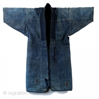 Boro Noragi - Meiji-era Indigo Cotton and Hemp Blend.

Thick, handspun indigo noragi with many mending patches. 

This jacket is heavy and warm and shows many, many years of use, but it still  ...