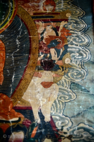 18th Century Thangka Depicting Shakyamuni Buddha, A stunning Tibetan thangka with Shakyamuni Buddha seated atop a lotus throne with hands in bhumisparsa mudra, surrounded by intricate narrative scenes with very fine details,  ...