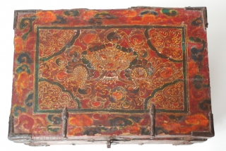 18c embossed zeebag chest, with a central medallion of the mythical zeebag beast and a reddish-orange background with swirls of light yellowish-brown. The painted surface on leather binding is raised lacquer gesso  ...