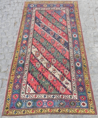 Caucasian Gendje long Rug with diagonal stripes, nice colors (especially the purple), vibrant field with botehs (or earrings), interesting border design with whirling logs?, 4x7.6 ft (122x232 cm), second half 19th century. 