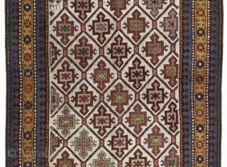 43x100 inches (110x255 cm). An ivory ground Karabagh long rug with a distinctive all over design of integrated shield and cross motifs and an attractive yellow main border of alternating terracotta and  ...