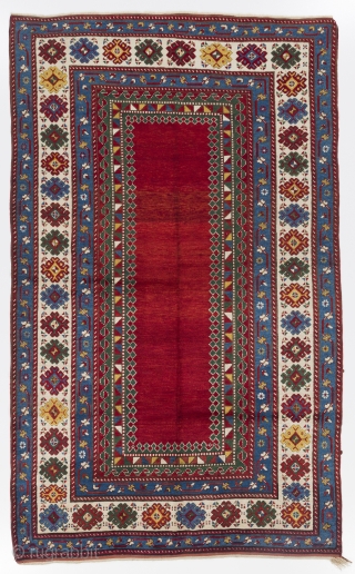 A top notch antique kazak rug with an eye catching plain red field, South Caucasus, ca 1890, 175x282 cm, very good condition, full pile, all original as found. Deep washed professionally.  