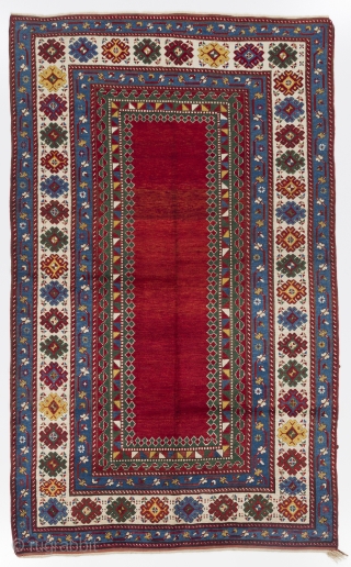A top notch antique kazak rug with an eye catching plain red field, South Caucasus, ca 1890, 175x282 cm, very good condition, full pile, all original as found. Deep washed professionally.  
