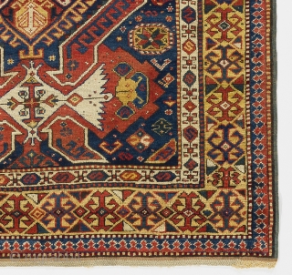 a handsome Kuba rug from North East Caucasus with shield, arms and dragons on a beautiful indigo blue ground framed by a rare yellow border. Very good condition with full pile and  ...