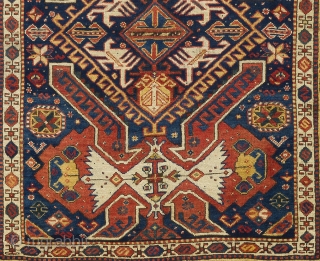 a handsome Kuba rug from North East Caucasus with shield, arms and dragons on a beautiful indigo blue ground framed by a rare yellow border. Very good condition with full pile and  ...