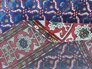 A Splendid Caucasian Kuba Rug with hexagonal lattice design on a light and dark indigo blue field enclosing flowering plants framed by a madder border with white kufi design. All natural dyes,  ...