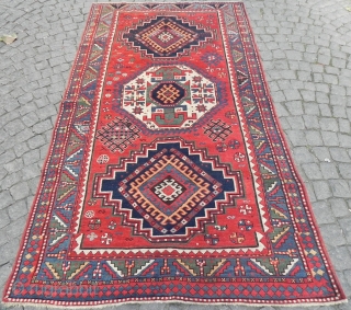 Large Caucasian triple medallion Kazak Rug, 257x143 cm, excellent condition, original ends and sides, late 19th century.                