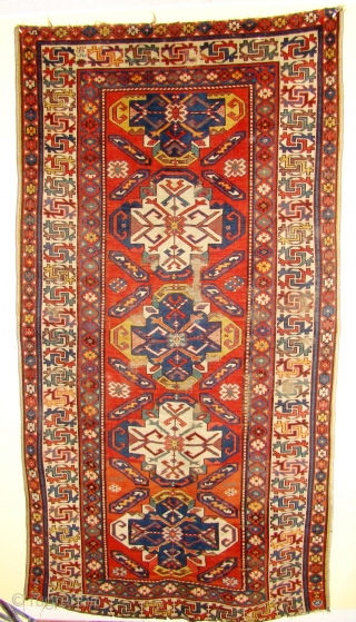 Handsome Caucasian long rug with great colors. 45-48 X 88 inches 115X224 Cm. There are a few small holes and some wear, both rows of the black are under the machine overcast  ...