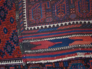 Baluch rug with Botteh border. The background is dark red and ornaments are a lighter red. All original. 40X78 inches 102X198 Cm.           