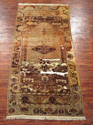 Antique Turkish long rug. Floppy handle like a thin blanket. All the old unfinished re-piled areas are on the original foundation. Knots are asymmetrical open to left. 

Size: 5'3"X11'5"    