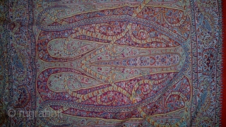 A 19TH CENTUARY WOVEN KASHMIR LONG SHAWL FROM INDIA. ITS A BEAUTIFUL SHAWL WITH DEEP RED CENTER. THE BEAUTIFUL BOTEH DESIGNS ON EITHER SIDES ARE VERY ELEGENT WITH LEAVES AND STEM RIBBONS  ...