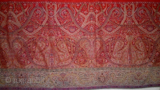 A 19TH CENTUARY WOVEN KASHMIR LONG SHAWL FROM INDIA. ITS A BEAUTIFUL SHAWL WITH DEEP RED CENTER. THE BEAUTIFUL BOTEH DESIGNS ON EITHER SIDES ARE VERY ELEGENT WITH LEAVES AND STEM RIBBONS  ...