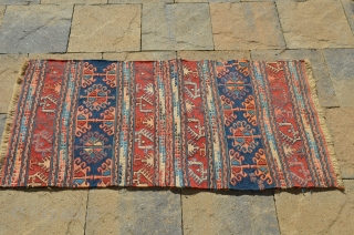 An interesting Soumak mat, actually a pair of bag faces that were put together, each bag measures 23" x 22" making the mat 46" x 22".       