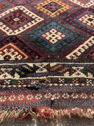 Fine Jaff bag face with an unusual color palette featuring two purples. Nice saturated dyes. Obvious condition issues but still a really great piece with a good range of colors. The wonky  ...
