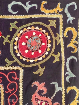 A dynamic Antique Uzbek silk suzani / Susani dating to late 19th Century from rural areas of shahrisabz. It has fine chain stitched silk on a dark indigo silk woven ground. The  ...