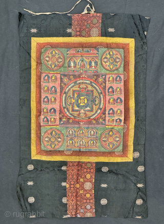 A beautiful antique Tibetan silk painted Buddhist Thangka from 19th century Tibet. At the centre of the colourful design is an elaborate Mandala with Buddha / Lama figures on each corner. The  ...