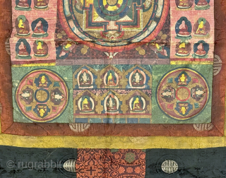 A beautiful antique Tibetan silk painted Buddhist Thangka from 19th century Tibet. At the centre of the colourful design is an elaborate Mandala with Buddha / Lama figures on each corner. The  ...