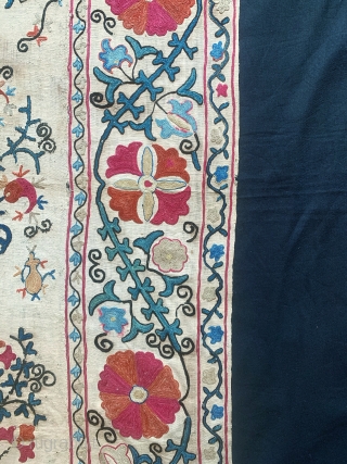 A lovely antique Uzbek silk suzani from 19th century rural Bukhara. It has fine polychrome silk chain-stitched embroidery on a cotton ground known as Karbos. The floral design is arranged in a  ...