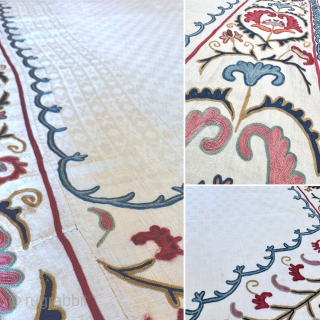 An outstanding antique Uzbek Shahrisabz silk Suzani, showcasing exceptionally fine silk chain-stitched embroidery on an unusual silk blend (?) textured and patterned white ground fabric. Dating close to mid 19th century, it  ...