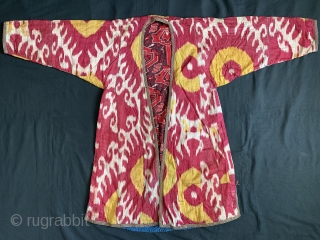 A beautiful Antique Uzbek Ikat Robe from Bokhara / Bukhara. It is an adras Ikat (silk warp/cotton weft) from third quarter of the19th Century. The archaic design with bold sun burst motifs  ...