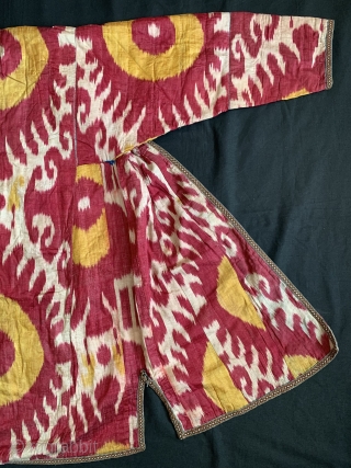 A beautiful Antique Uzbek Ikat Robe from Bokhara / Bukhara. It is an adras Ikat (silk warp/cotton weft) from third quarter of the19th Century. The archaic design with bold sun burst motifs  ...