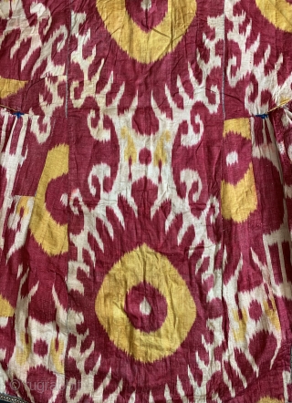 A beautiful Antique Uzbek Ikat Robe from Bokhara / Bukhara. It is an adras Ikat (silk warp/cotton weft) from third quarter of the19th Century. The archaic design with bold sun burst motifs  ...