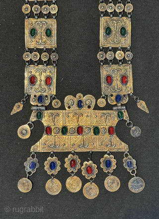 
An exceptional antique gold appliqué and silver Turkoman / Turkmen Yomut / Yomud tribe bridal necklace with the pendent in the shape of the tauk noska motif (double headed bird) . It  ...