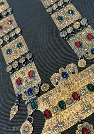 
An exceptional antique gold appliqué and silver Turkoman / Turkmen Yomut / Yomud tribe bridal necklace with the pendent in the shape of the tauk noska motif (double headed bird) . It  ...