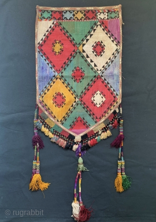 An excellent example of Antique Uzbek Lakai tribe silk cross stitched shield shaped talismanic hanging known as Uut Kap Ilgich, dating to the 19th century. This is one of the coveted examples  ...